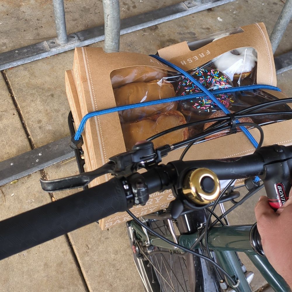 Front bike rack with two boxes of donuts