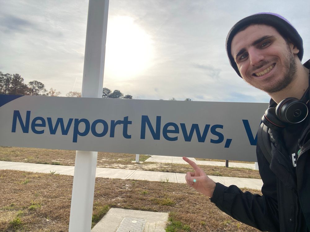 Me pointing at the Amtrak sign for Newport News.
