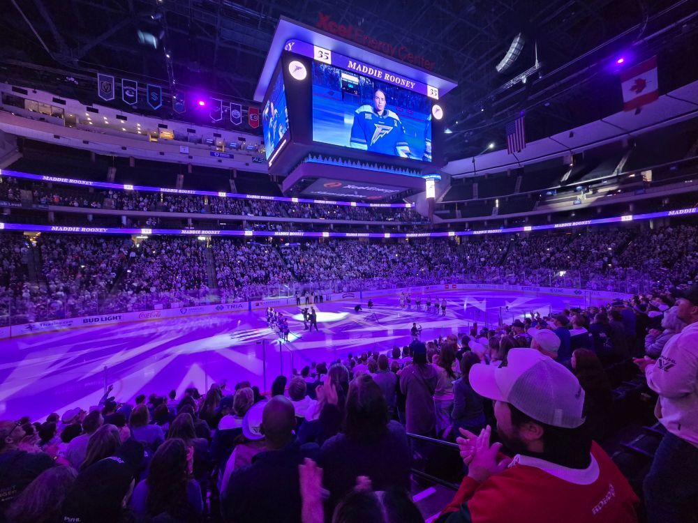 Hockey rink bathed in purple light.