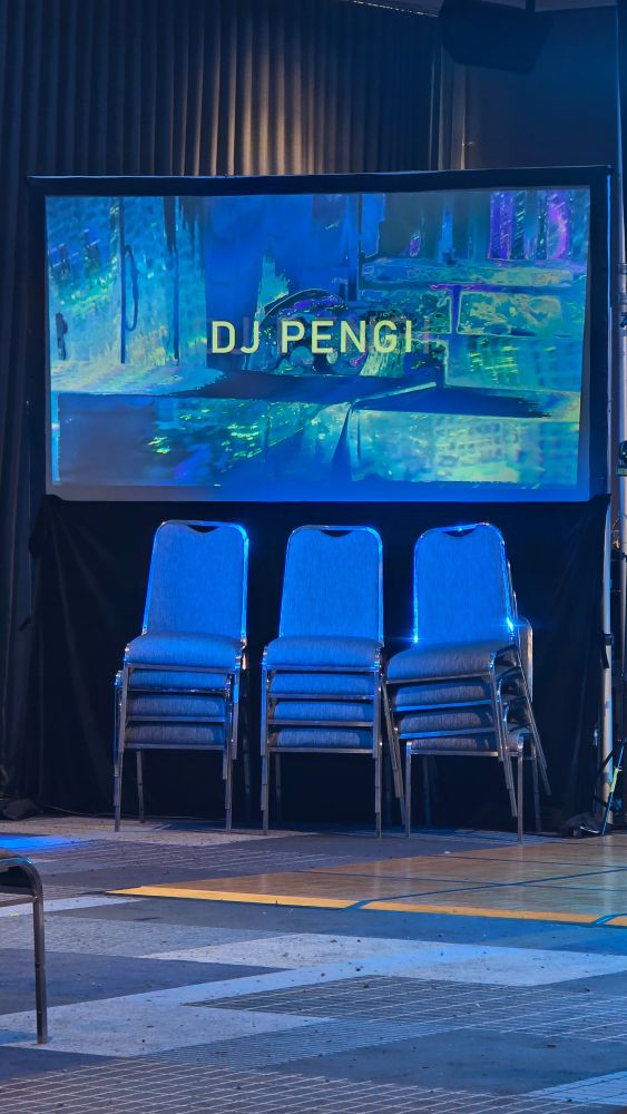 A blue toned photo with "DJ PENGI" across the screen.