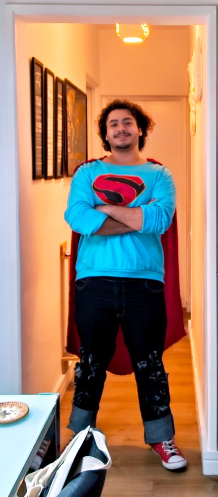 Superman cosplay pic.
A blue rolled up long sleeve shirt with a S crest