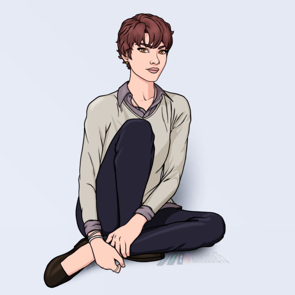 Kate Pryde sits against a pale bluish wall. She's wearing a sweater, blouse, and jeans, with her hair cut short and a little bit wild.