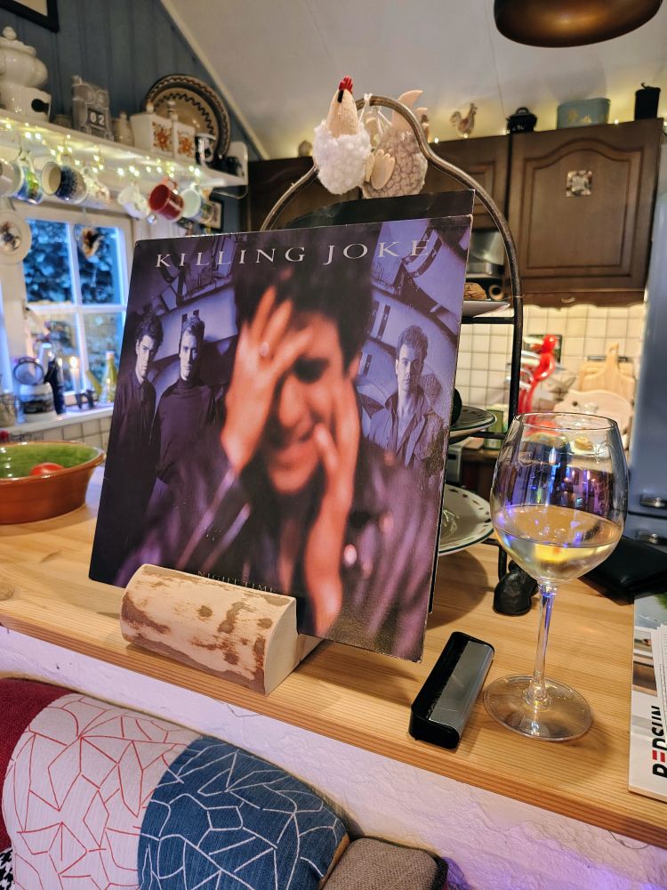 Killing joke night time vinyl album with a glass of Pouilly Fume 