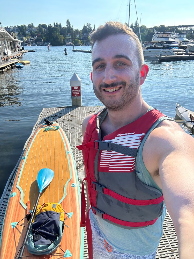 Me standing by the paddle board on the dock