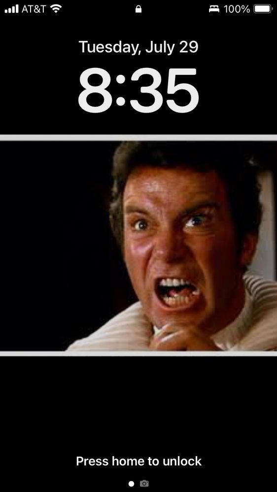 An iPhone lock screen.  The background image is Capt. Kirk shouting "KHAN!" from Star Trek 2 : The Wrath of Khan.  

It's 8:35 in the AM on Tuesday, July 29th.  Battery is fully charged.  Wifi and cel signal are at full strength.  

I miss my old chair. 
