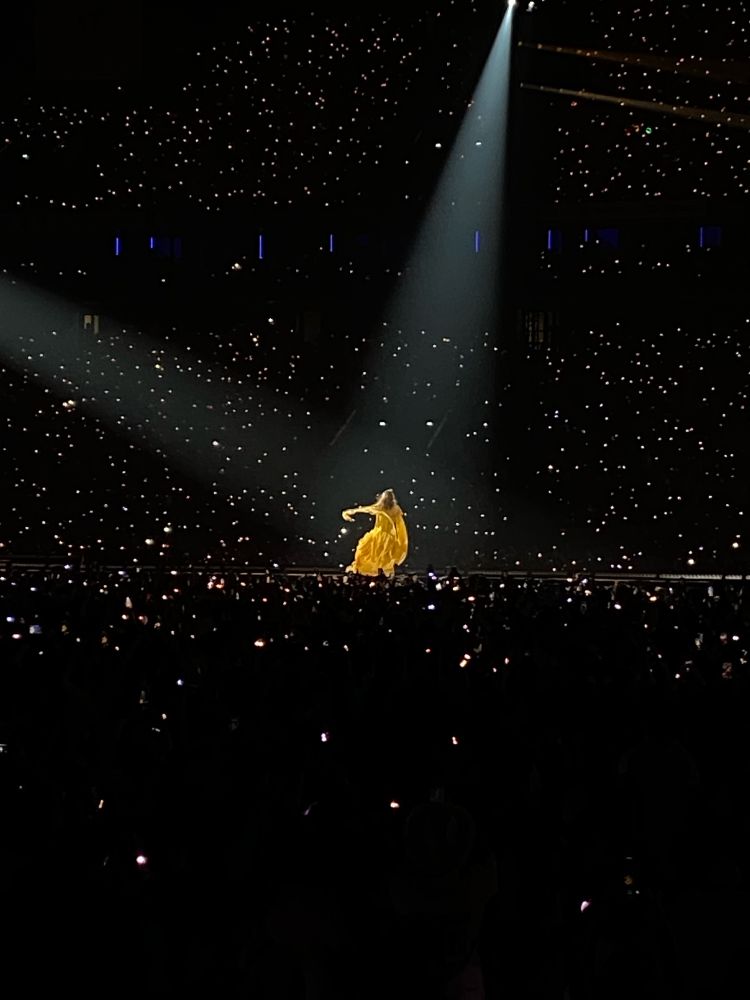 Taylor Swift performing wearing the yellow folkmore dress