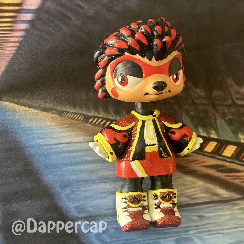 A hand-painted custom hybrid mini doll inspired by Shadow the Hedgehog, standing in one of the corridors of the ARK station.

Head came from a Littlest Pet Shop Hedgehog and the outfit/body came from a Yummiland keychain doll.