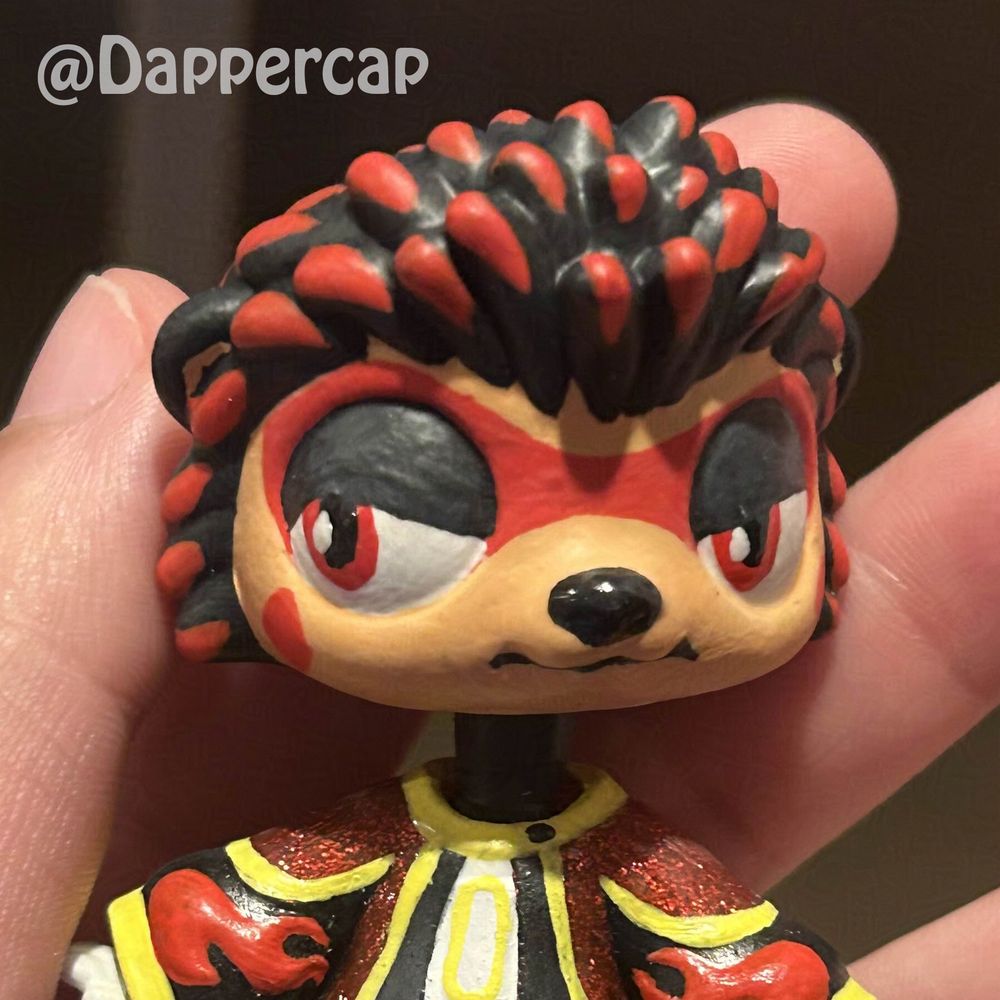A hand-painted custom hybrid mini doll inspired by Shadow the Hedgehog, standing in one of the corridors of the ARK station.

Head came from a Littlest Pet Shop Hedgehog and the outfit/body came from a Yummiland keychain doll.