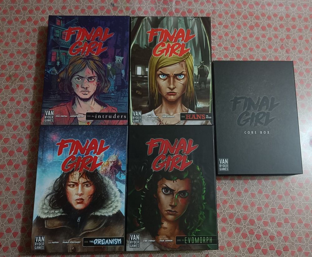 The picture shows five boxes of the Final Girl board game, which includes the Core Box, The Happy Trails Horror, Into the Void, A Knock at the Door, and Panic at Station 2891 feature films.