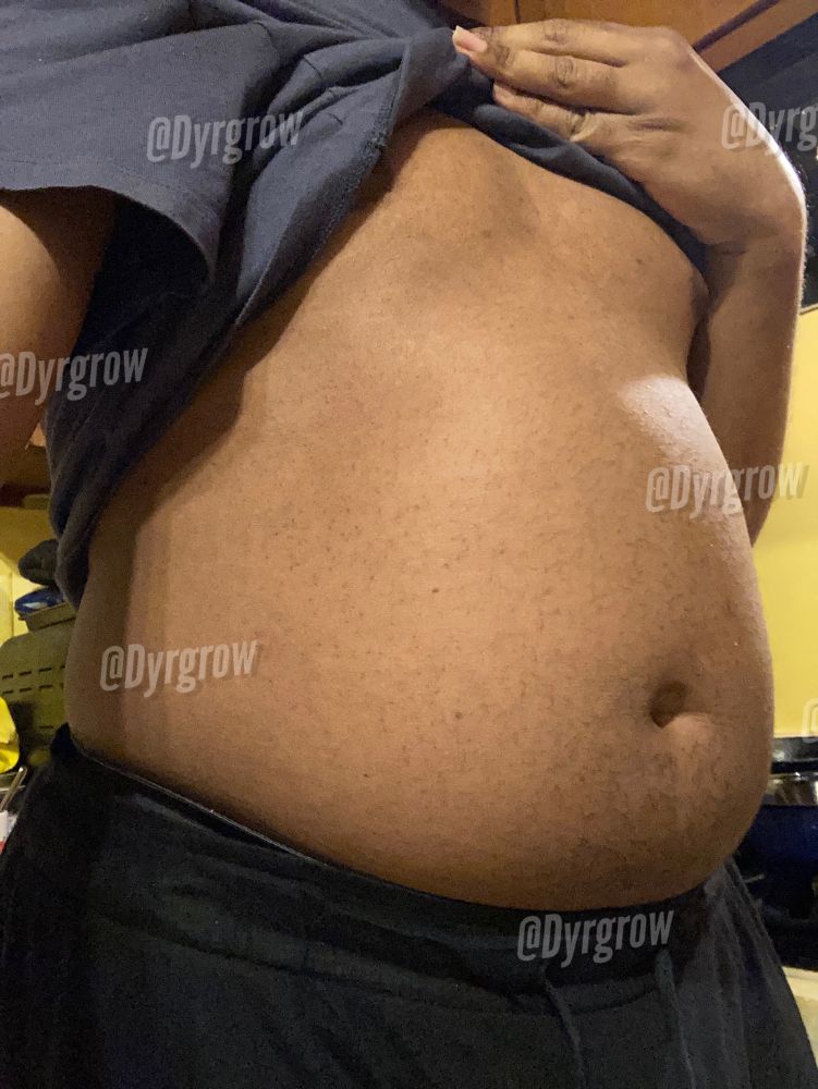 Pulling up my dusk blue top to show off my already partly full belly before my night session of meals.