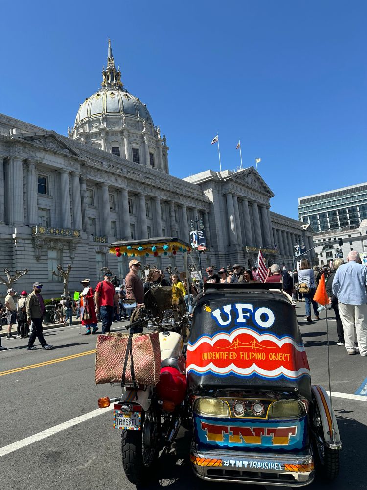 Tuktuk style sidecar in front of SF city hall. The back reads “unidentified Filipino object”. 