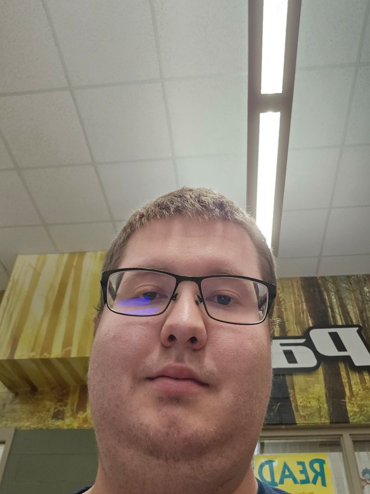 Me, the day my egg cracked. I had short hair, rectangular glasses, and badly shaven stubble