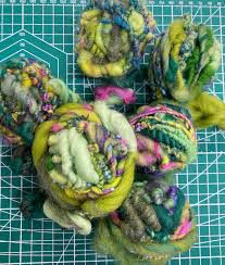 Yarns of mixed fibers: handspun from farm sourced merino wool, mohair from goats, recycled silks.  