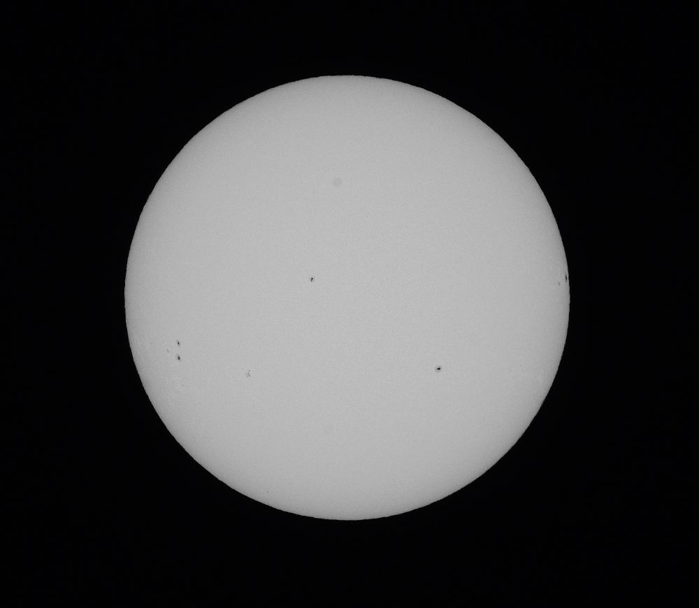 Image of the sun with several sun spots visible.
