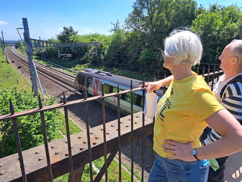 Bristol Rail Campaign team watch Cross Country train pass Ram Hill footbridge