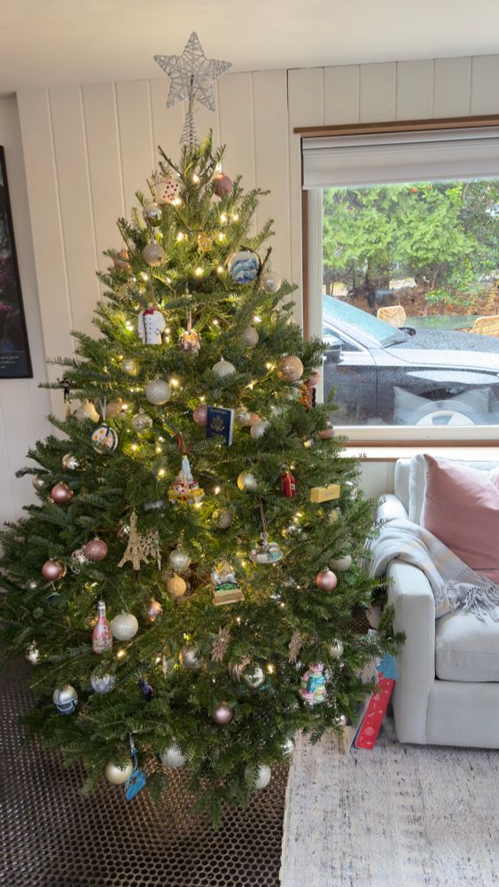 A 6 foot tree with holiday ornaments 