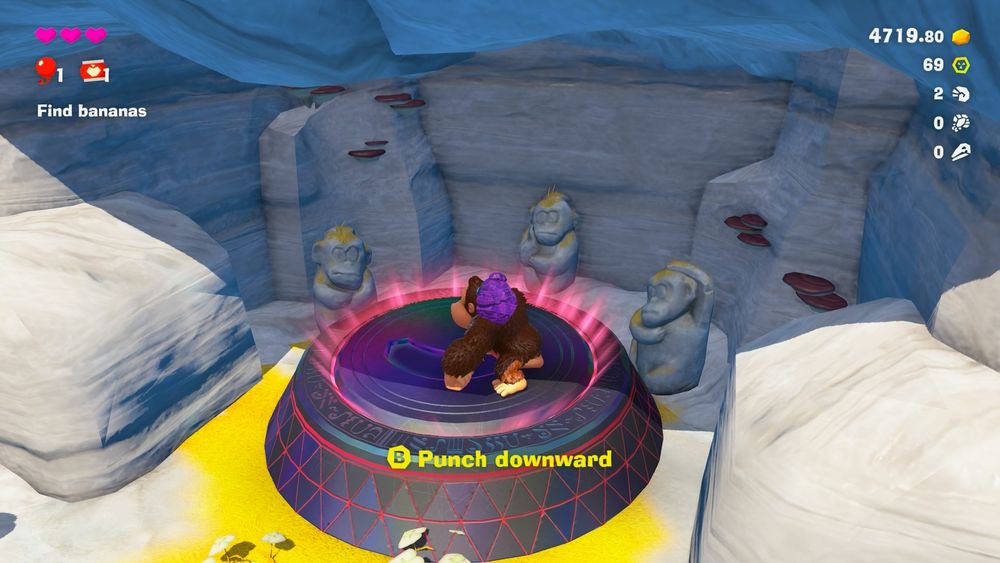 Donkey Kong stands on a ruin entrance. Punch downward appears on screen as an instruction.