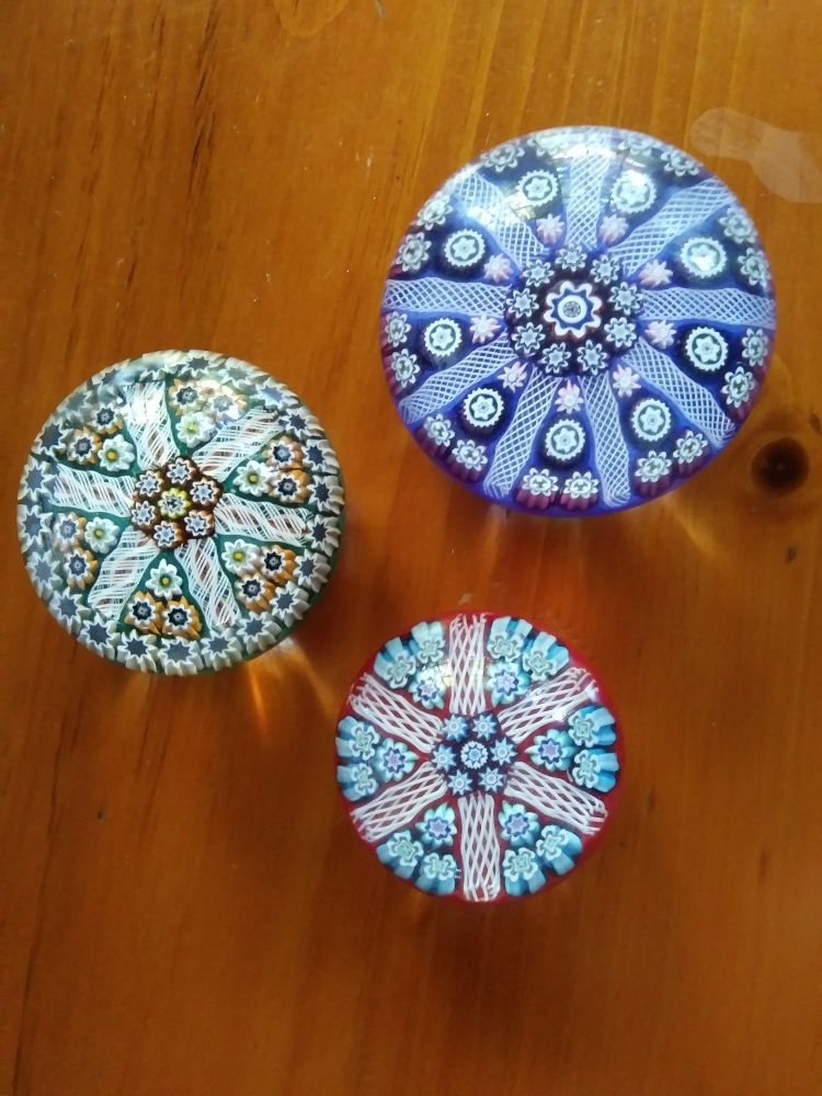 3 glass paper weights with intricate geometrical patterns
