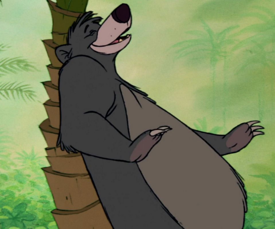 Baloo, the bear from The Jungle Book, scratching his back against a tree.