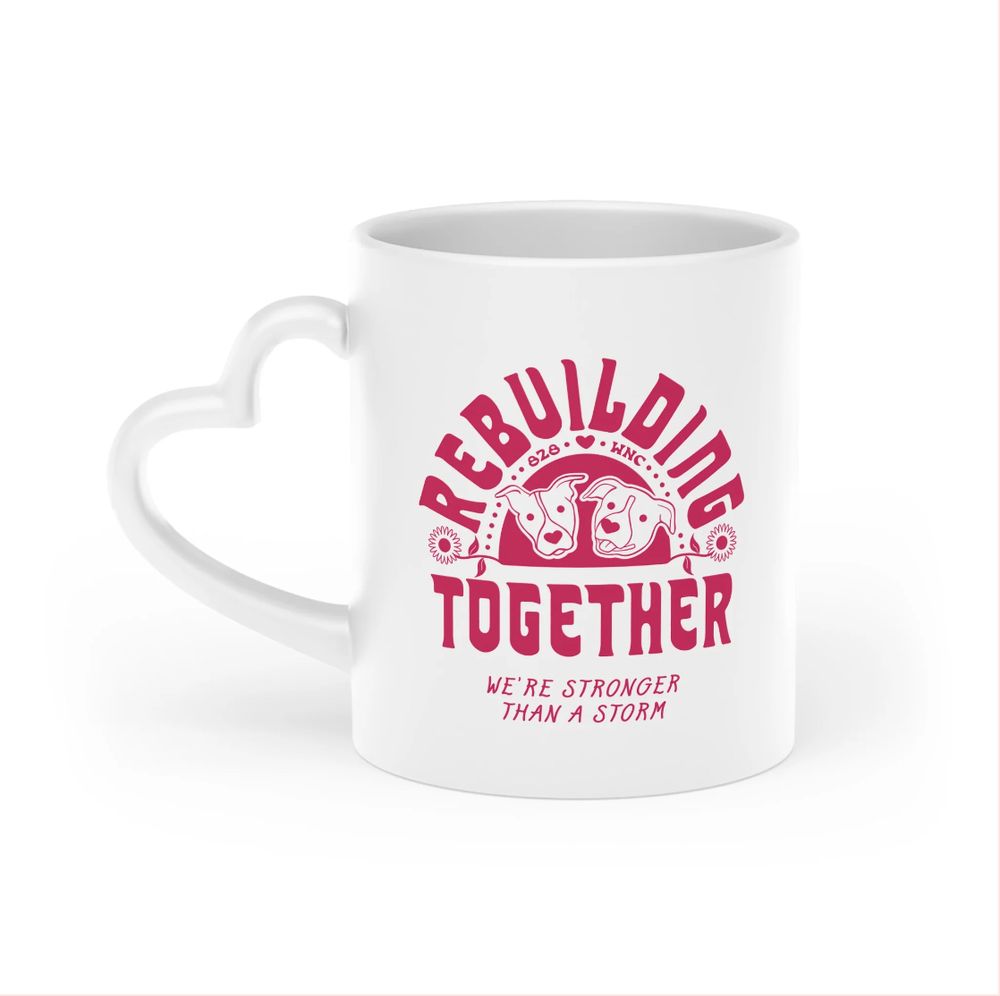 Rebuilding together mug in white and hot pink with a heart handle