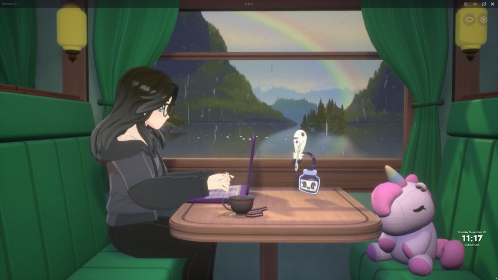 A screenshot of the game Spirit City: Lofi Sessions. It shows a girl with long black hair and black clothes typing on a computer while sitting on a green decorated train. There's a black tea cup on the table and a pet that looks like a bottle of ink and a quill. There's a unicorn plushies on the other seat. The window behind the girl shows it's raining, there's a lovely view of a lake with some forest and a rainbow in the sky.