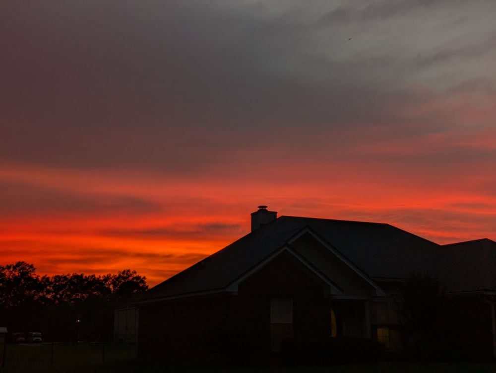 a cloudy, deep apricot summer sunset over our Mississippi neighborhood