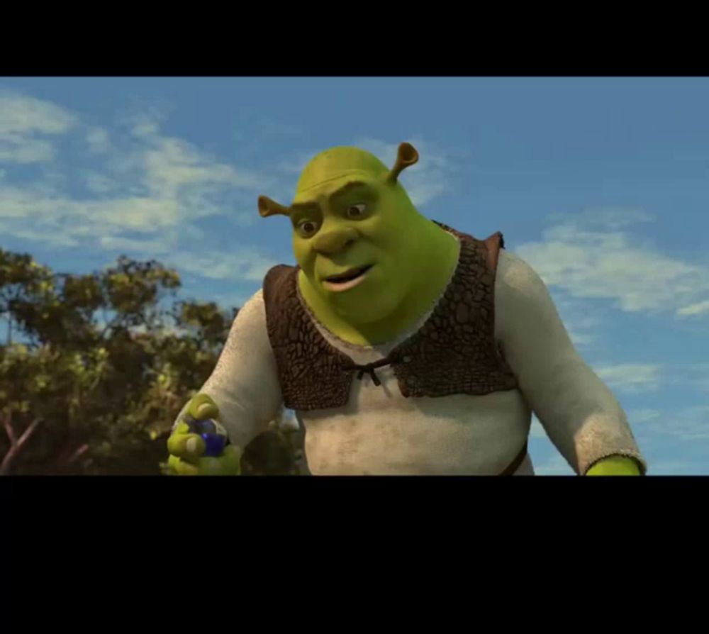 shrek from the movie shrek is holding a blue ball in his hand