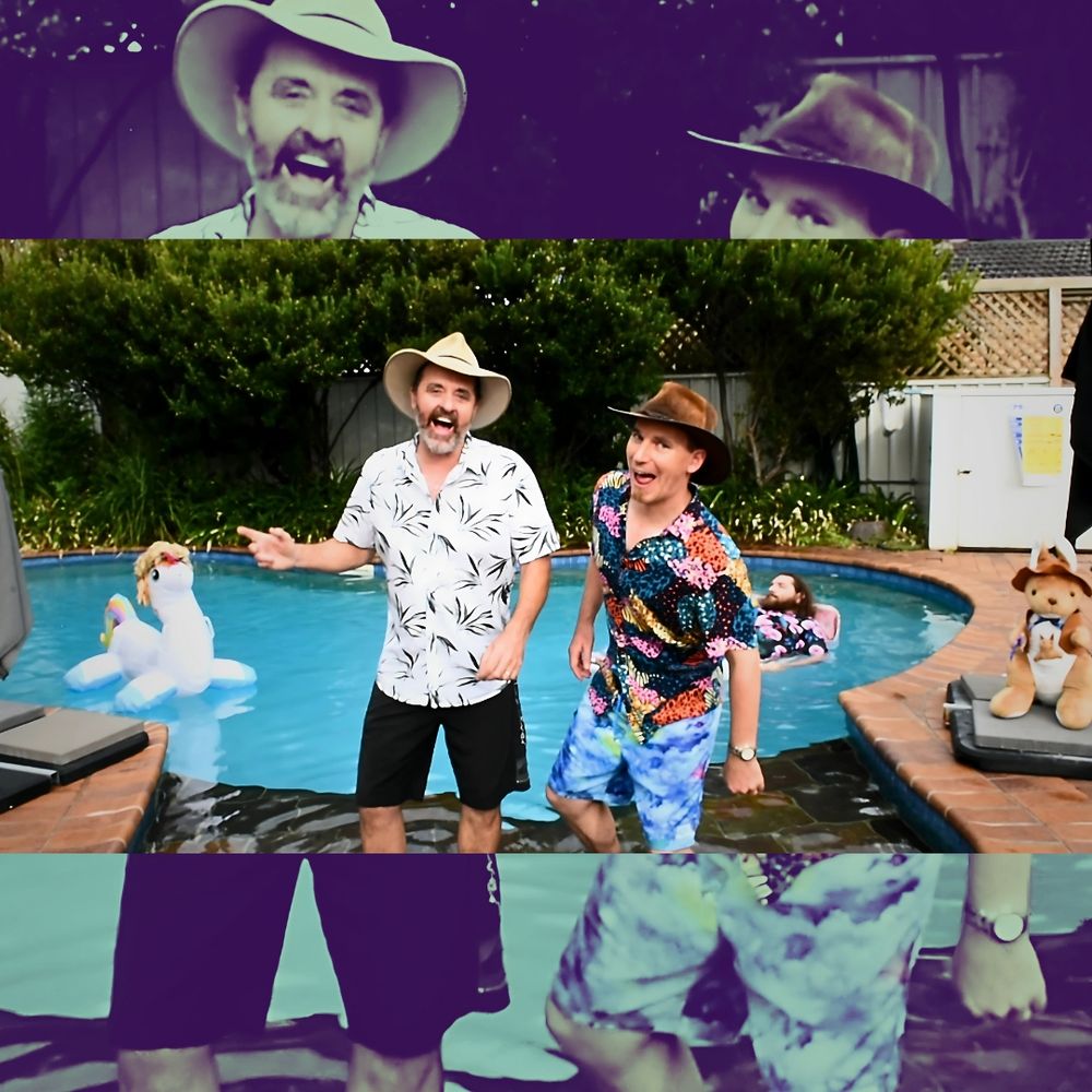 Two men in akubras wear hawaiian shirts and smile at the camera. They're in front of a pool with a bogan floating on a pool bed and a unicorn wearing a mullet