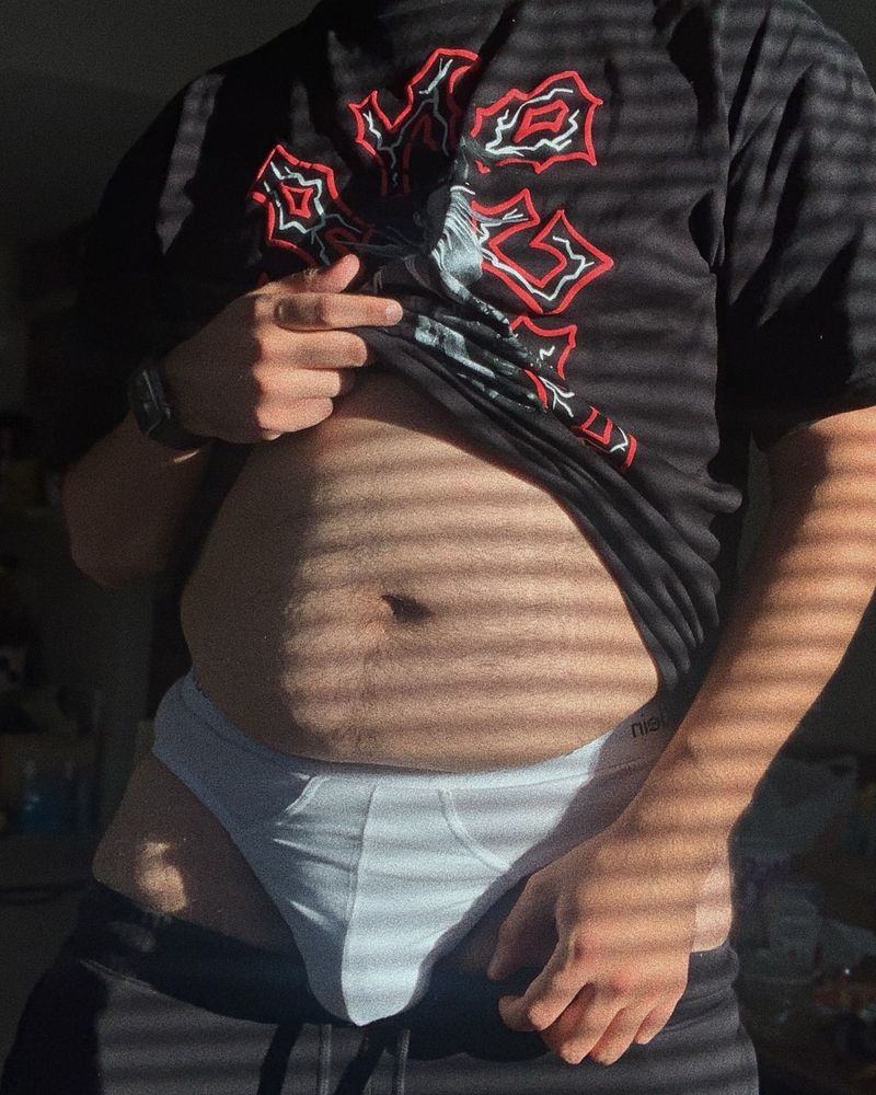 me lifting my shirt up showing belly and my shorts pulled down showing my bulge in white underwear, a mess in the background lol