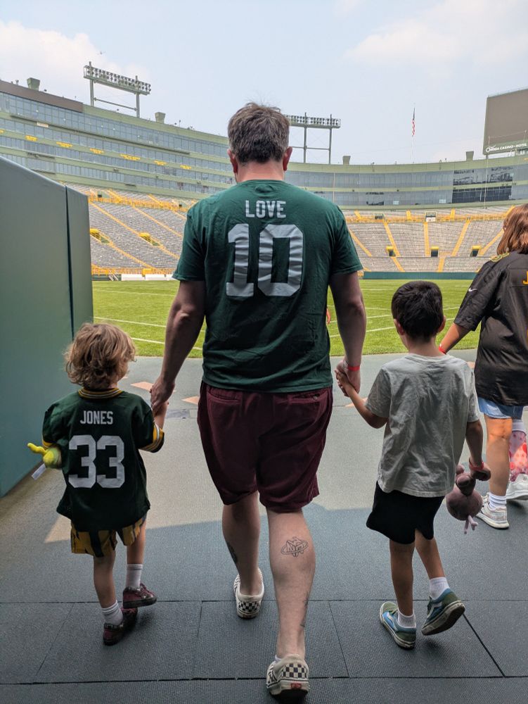 Me and my two kids holding hands and walking out of the Packers tunnel onto Lambeau Field during the stadium tour. Go Pack Go.