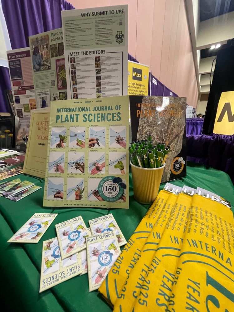 Chicago press booth at Botany2025, covered with journal issues and swag.
