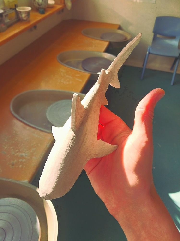 A very simple shark sculpture made from stoneware clay