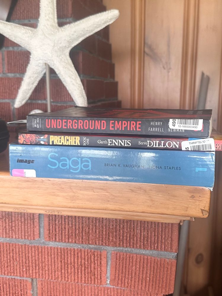 Stack of books on a mantle.