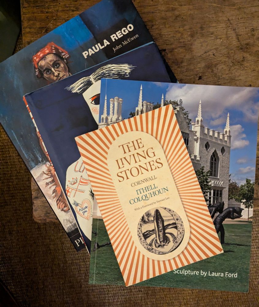 Stack of four books about Ithell Colquhoun, Laura Ford, Barbara Jones and Paula Rego on a wooden table top