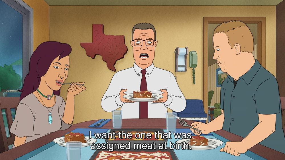 hank hill eating with bobby hill and his vegan girlfriend willow. there are two platters of lasagna in front of him, one with meat and one vegan. he is saying "i want the one that was assigned meat at birth"