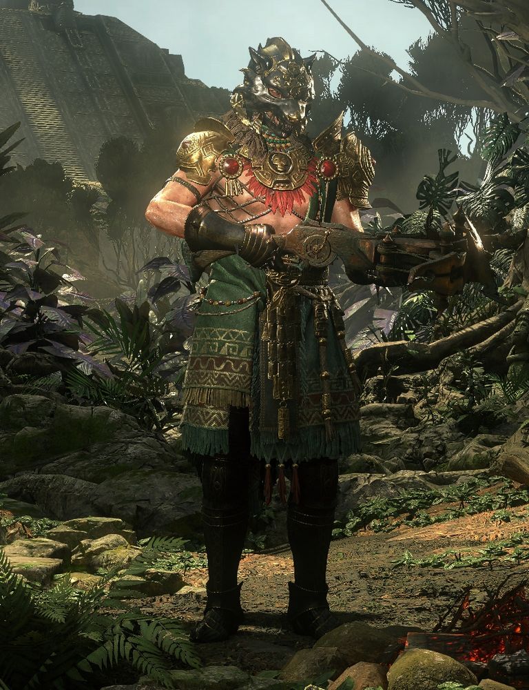 A screenshot of a mercenary character from Path of Exile 2, a white male. He stands welding a crossbow in a neutral pose, wearing an Aztec-inspired combination of gold armor and draped robes with intricate detail in both the metal and the cloth. Much of his chest and arms are exposed. He wears a helmet shaped like a wolf's head, which obscures most of his face, as well as metal gauntlets and greaves which reflect similar shape language and color to the helmet-- a dark sooty black with gold trimming. The environment he stands in is one of a lush jungle brimming with foliage. Far in the distance, a ziggurat-like structure looms. The weather in the setting is fair.