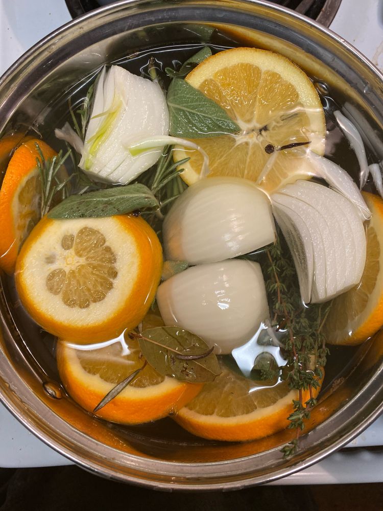 pot with slice oranges, onions, herbs, and more to brine a turkey for thanksgiving, no butterball