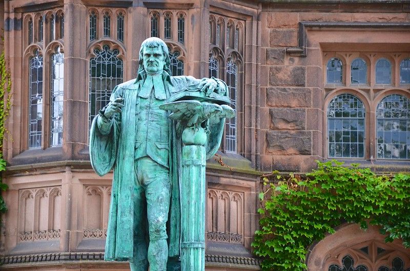 A 2001 verdigris bronze sculpture of former Princeton president John Witherspoon, by Alexander Stoddart, outside East Pyne Hall. By Joe Shlabotnik via Flickr, CC BY-NC-SA