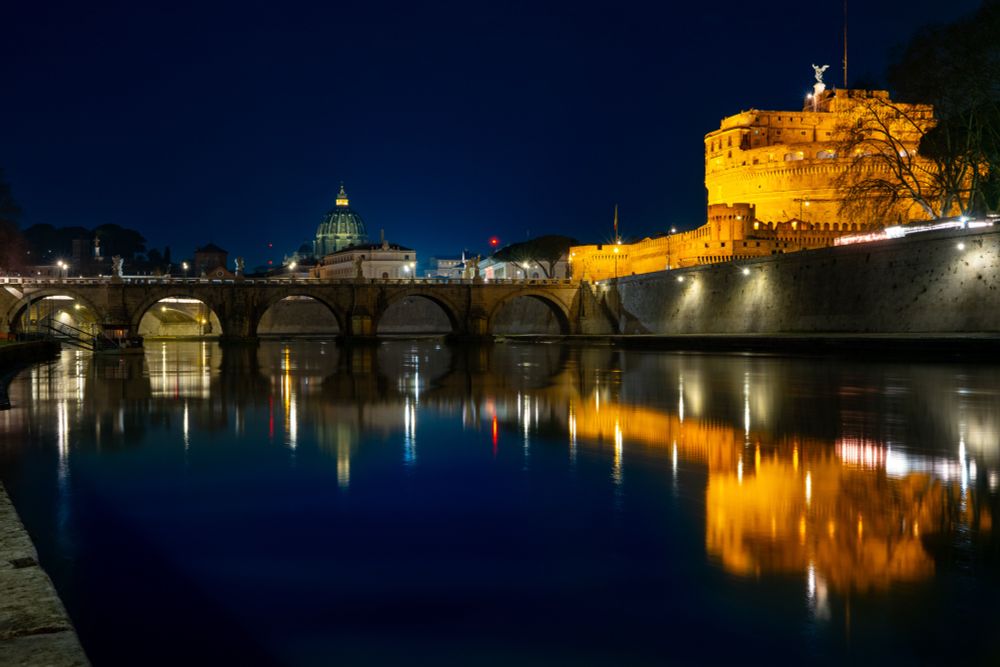 Castel Sant’Angelo and Basilica san Pietro by night reflecting on the Tiber