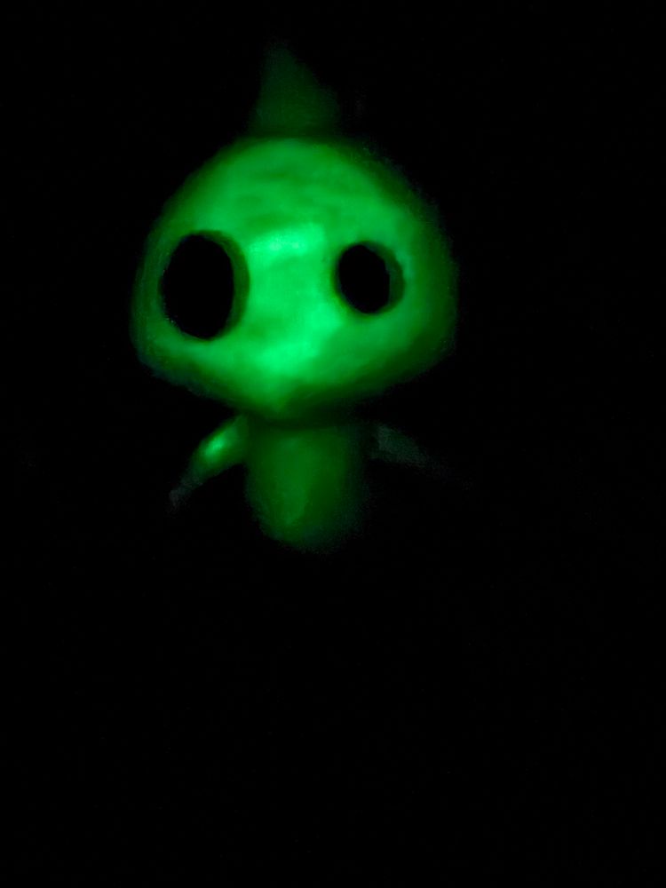 picture of a glow pikmin plush in the dark 