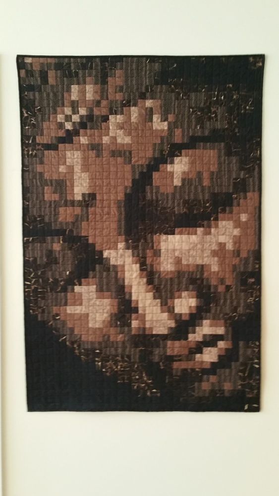 pixellated quilt of an image of a buddha
