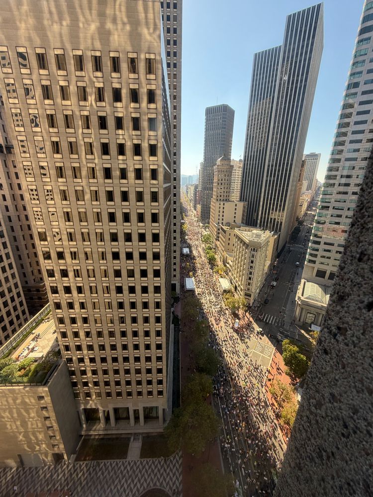 A view from above of a protest march down Market Street looking west