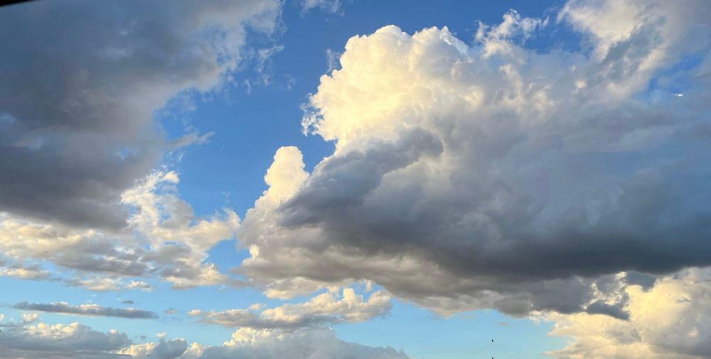 Blue skies and white fluffy clouds mixed with gray rain clouds in Phoenix, Arizona. 