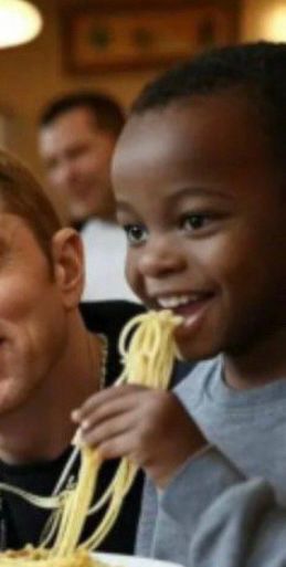 A kid eating spaghetti like it’s a breadstick