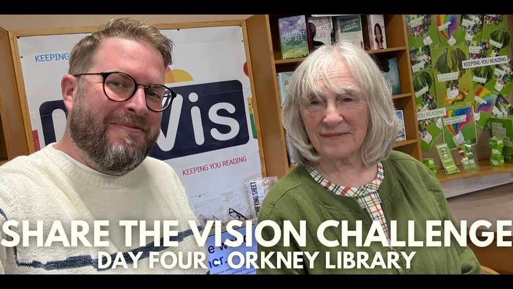 A thumbnail image from the video of Simon and Jean in the library. Text on the image reads Share the Vision Challenge, Day Four Orkney Library. 