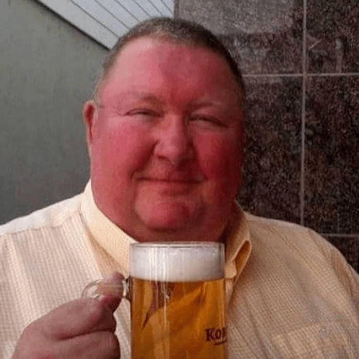 An absolute bloke having a pint. 