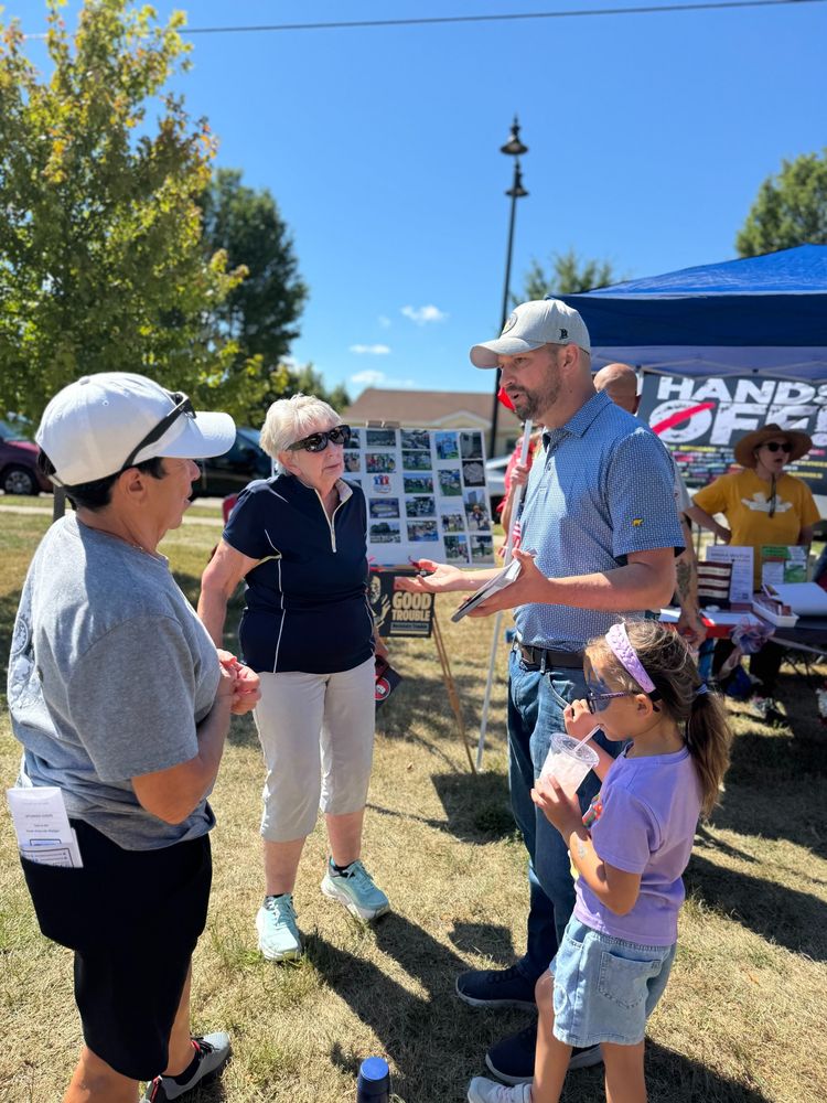 Mitchell talks with voters in a park