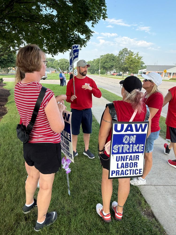 Mitchell, carrying a picket sign, joins striking nurses outside a hospital in Janesville
