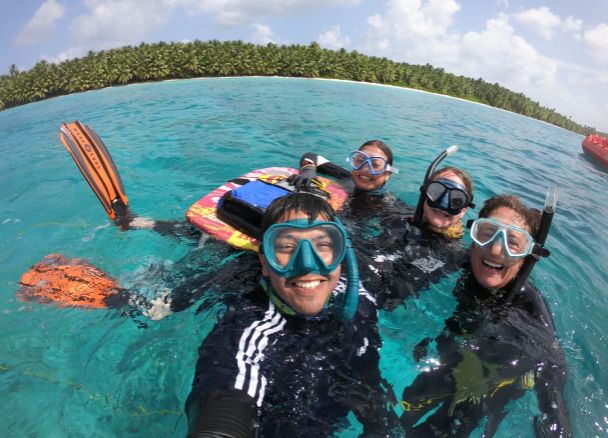 Javier, Laura-Li, Ruth, and Casey in the sea in their snorkelling kit during their last day of fieldwork.