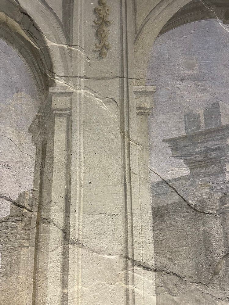 An area of a fresco’d wall where areas of damage are highlighted by placing light close to the wall and shining along the surface to see the contrasting areas. 